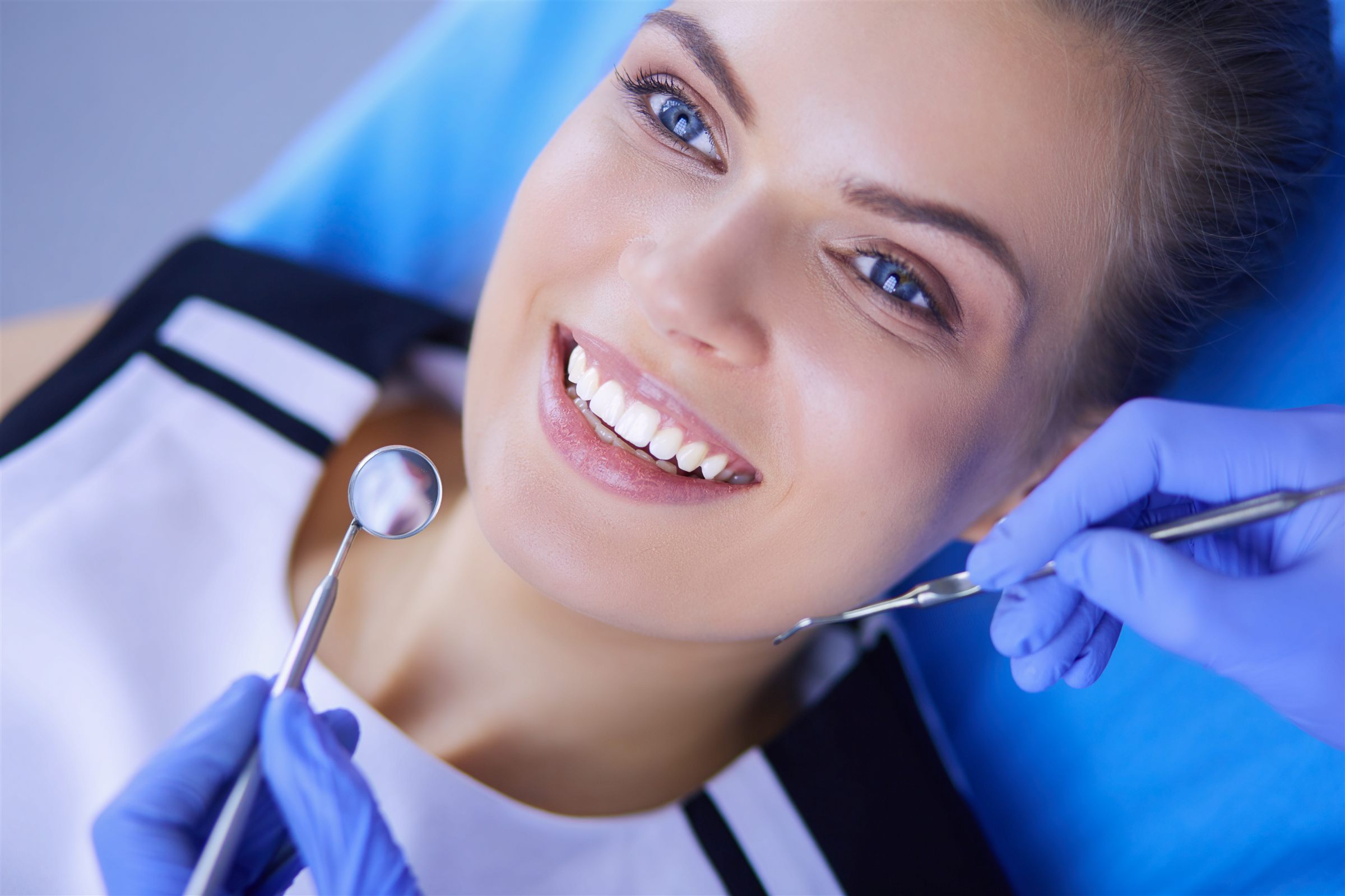 Smiling dental patient during an exam at Caring Dental of Herndon